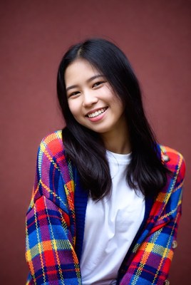 Smiling person in colorful sweater