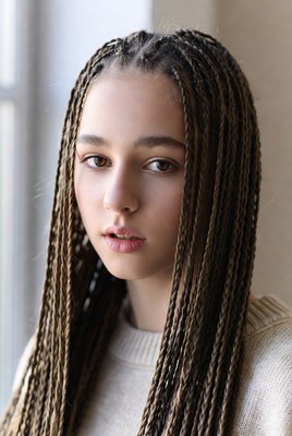 Girl with braided hair in indoor setting
