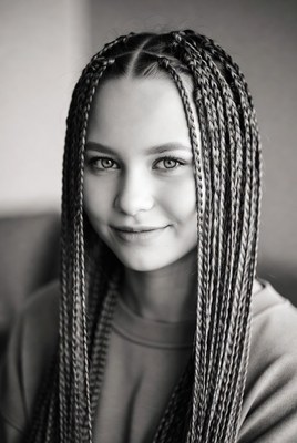 Young girl with braided hair in black and white