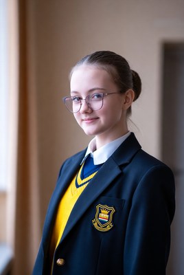 Student in school uniform by window