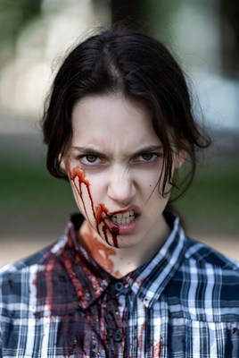 Girl with blood on face in park
