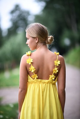 Woman in yellow dress walks outdoors