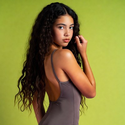 Young person posing against bright background