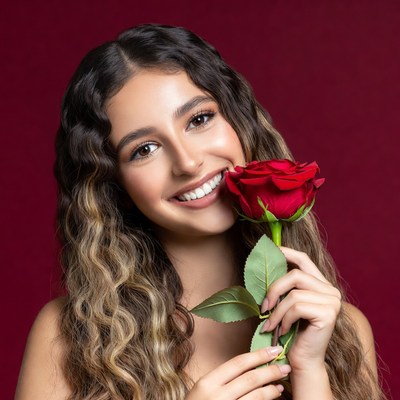 Woman holding a rose indoors