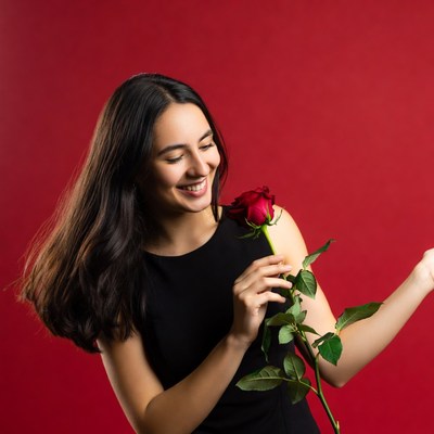 Woman holding rose in studio