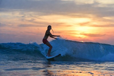 Surfing at sunset on the beach