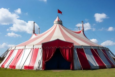 Red and white circus tent at outdoor event