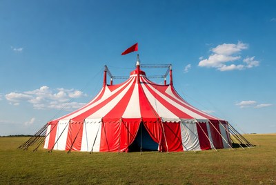 Big top tent stands in open field
