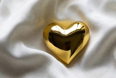 Golden heart shape on white fabric