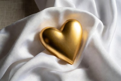 Golden heart on white fabric