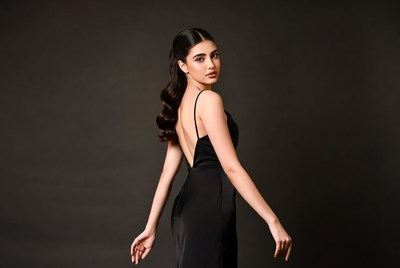 Model poses in black dress