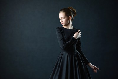 Young woman in black dress posing