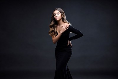 Woman in black dress poses