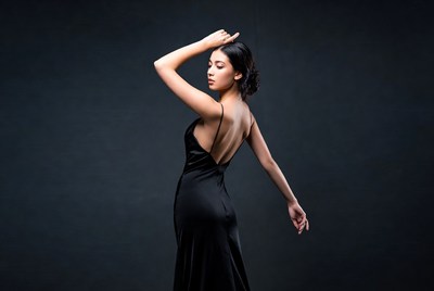 Model poses in black dress