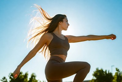 Woman practicing dance at sunset
