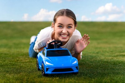Child enjoying toy car outdoors