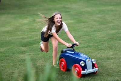 Girl playing with toy car outside