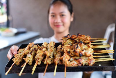 Grilled skewers served by vendor in local market