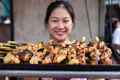 Grilling skewers at a street market