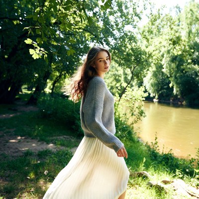 Woman walks by river in nature