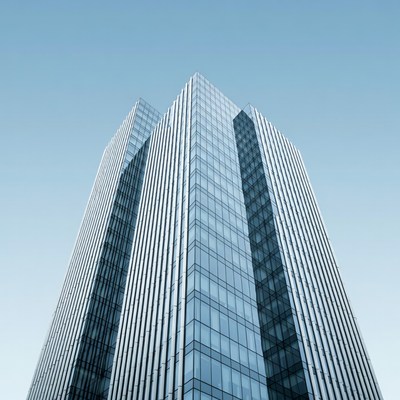 Modern glass building reaching sky