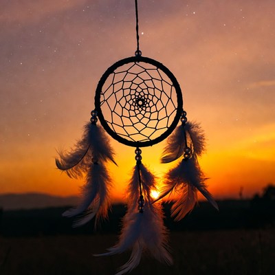 Dream catcher at sunset sky