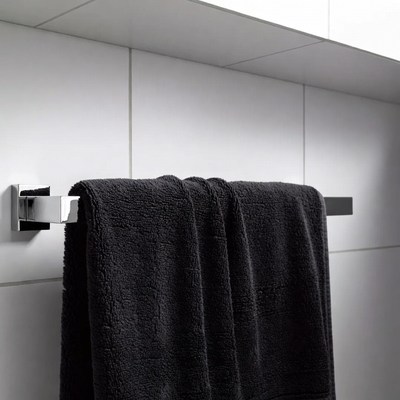 Black towel hanging on rack in bathroom