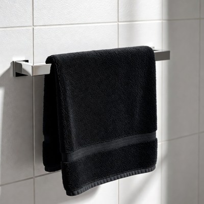 Black towel hanging in bathroom