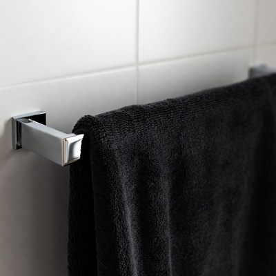 Black towel on metal rack in bathroom