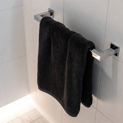 Black towel hanging in bathroom
