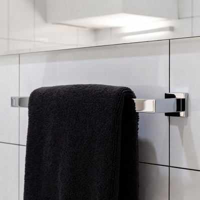 Black towel hanging in bathroom