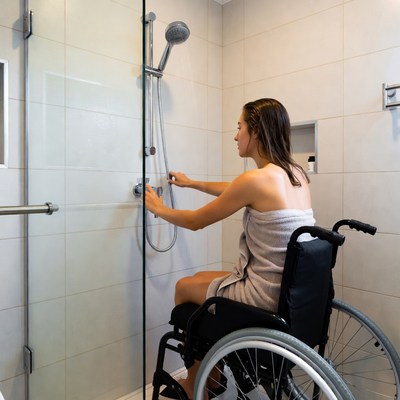 Woman using shower in wheelchair