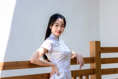 Woman posing by wooden fence