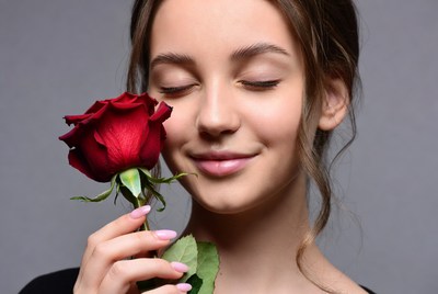 Smiling girl with rose flower