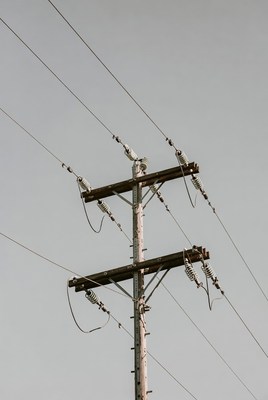 Utility pole with power lines against sky