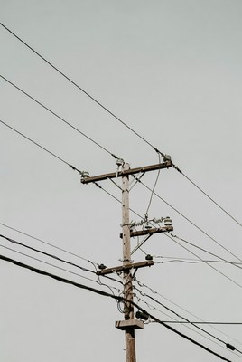 Power lines against cloudy sky