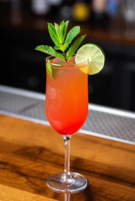 Colorful cocktail with citrus garnish on bar
