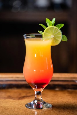 Colorful layered drink with lime