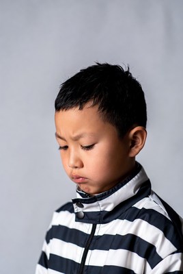 Young boy in striped jacket