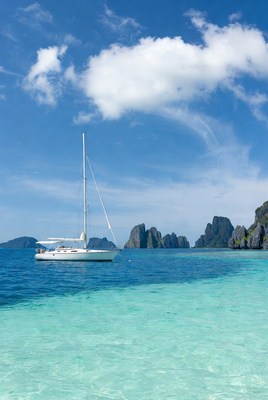 Sailing near rocky islands in clear water