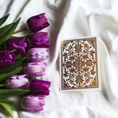 Purple tulips and card on fabric