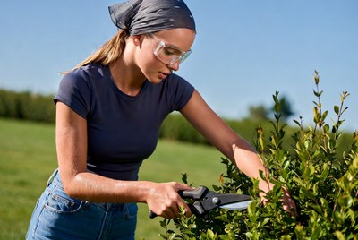 Woman trimming bushes in a garden