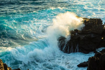 Waves crash against rocky shore