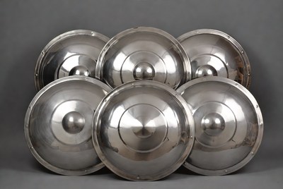 Six metal shields stacked together