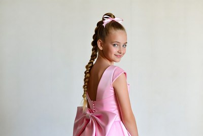 Girl in pink dress with ponytail