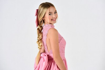 Girl smiling in pink dress with braid