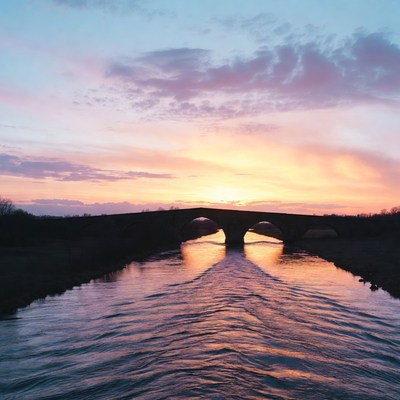 Sunset over river and bridge