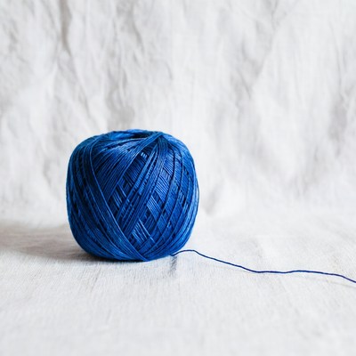 Blue yarn on a textured surface