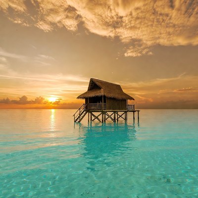 Sunset view of a water bungalow