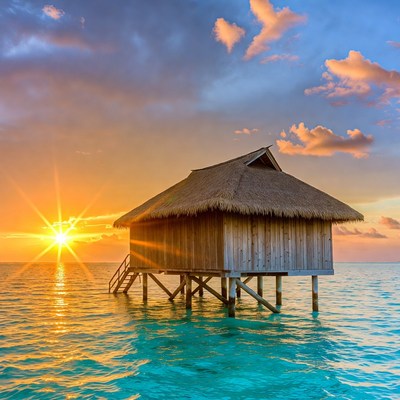 Sunset over a wooden hut in the sea